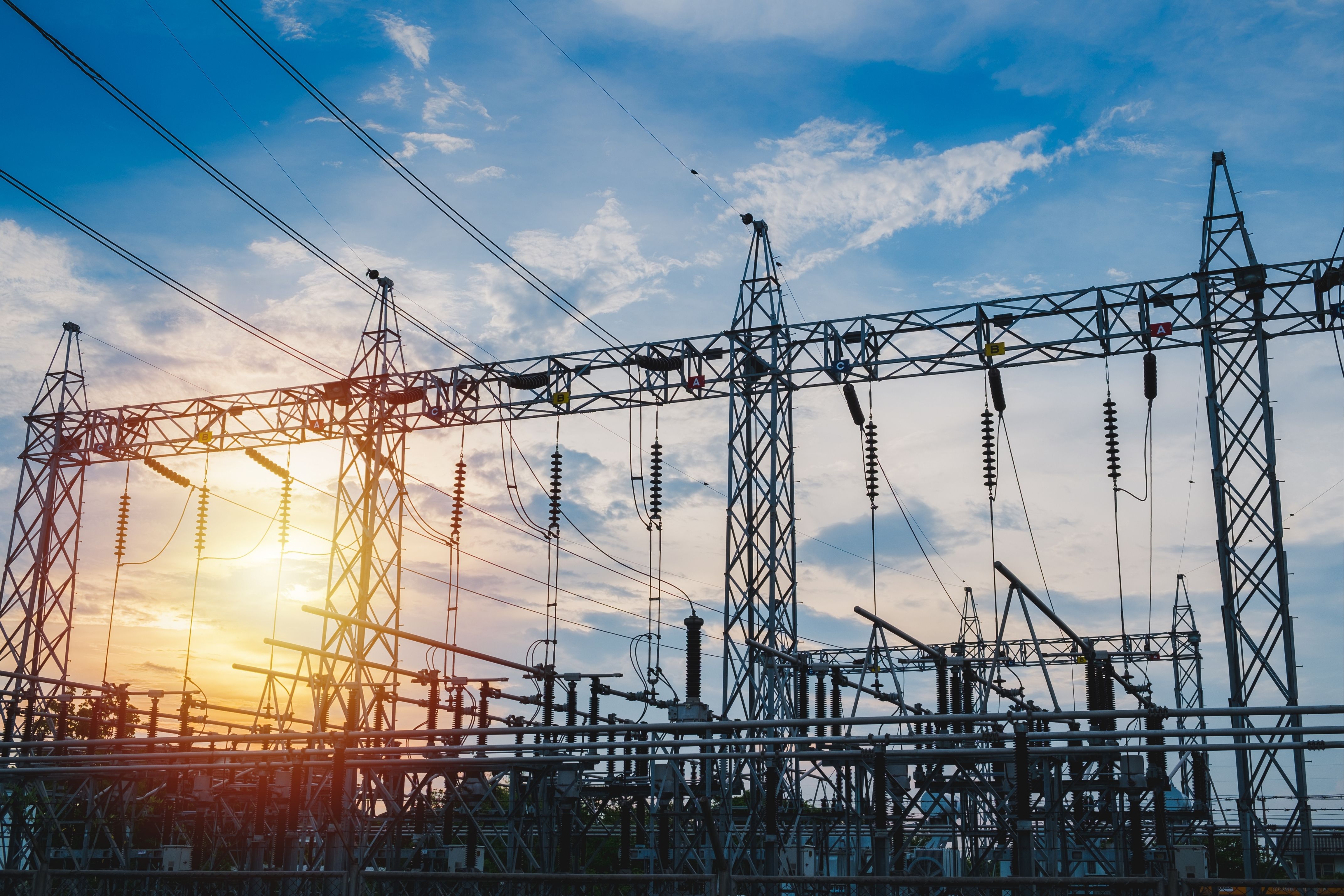 Power plant showing power lines in sunset